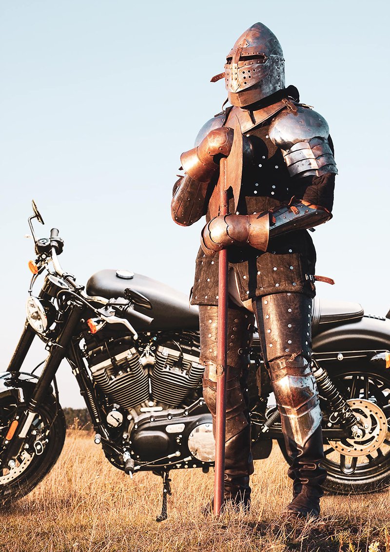 Knight in armour next to motorcycle